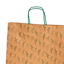 Bolsa de papel impresa con un estampado de hojas en color verde con asa retorcida o rizada.